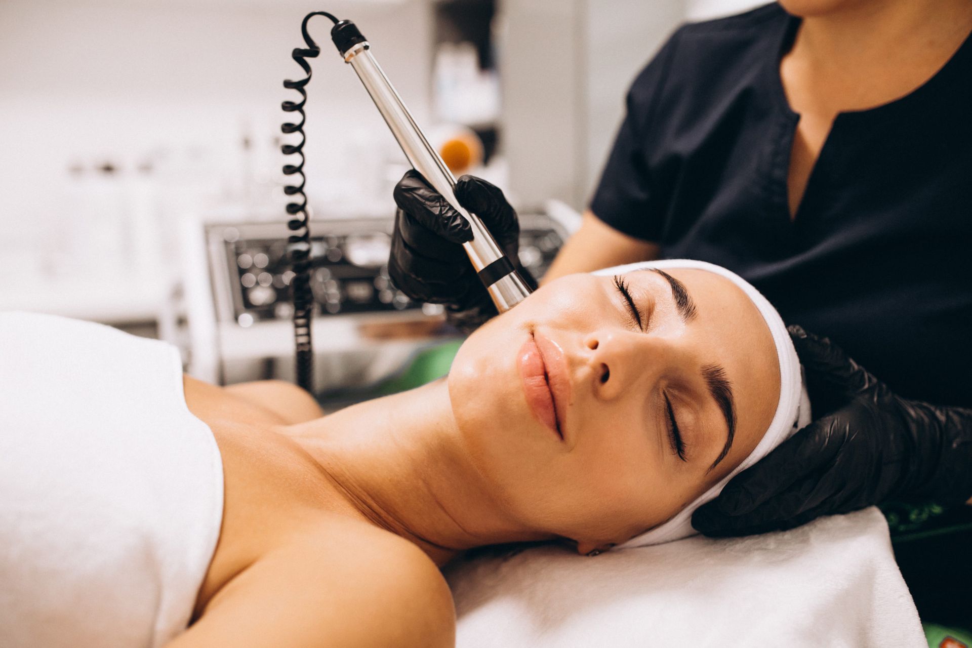 A woman is getting a facial treatment at a beauty salon.
