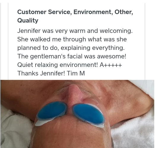 A woman is laying on a bed with blue glasses on her eyes.