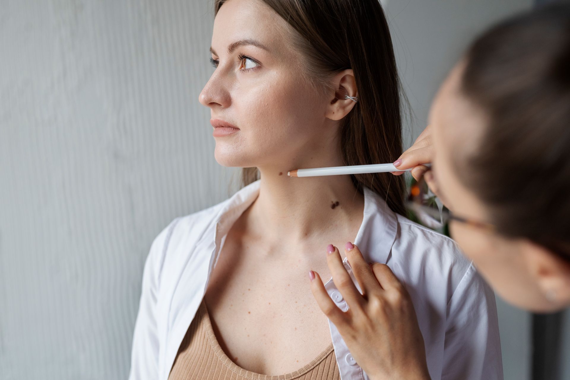 A woman is getting her neck measured by a doctor.