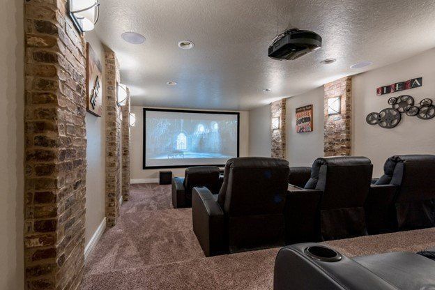 A home theater with a projector and a large screen.