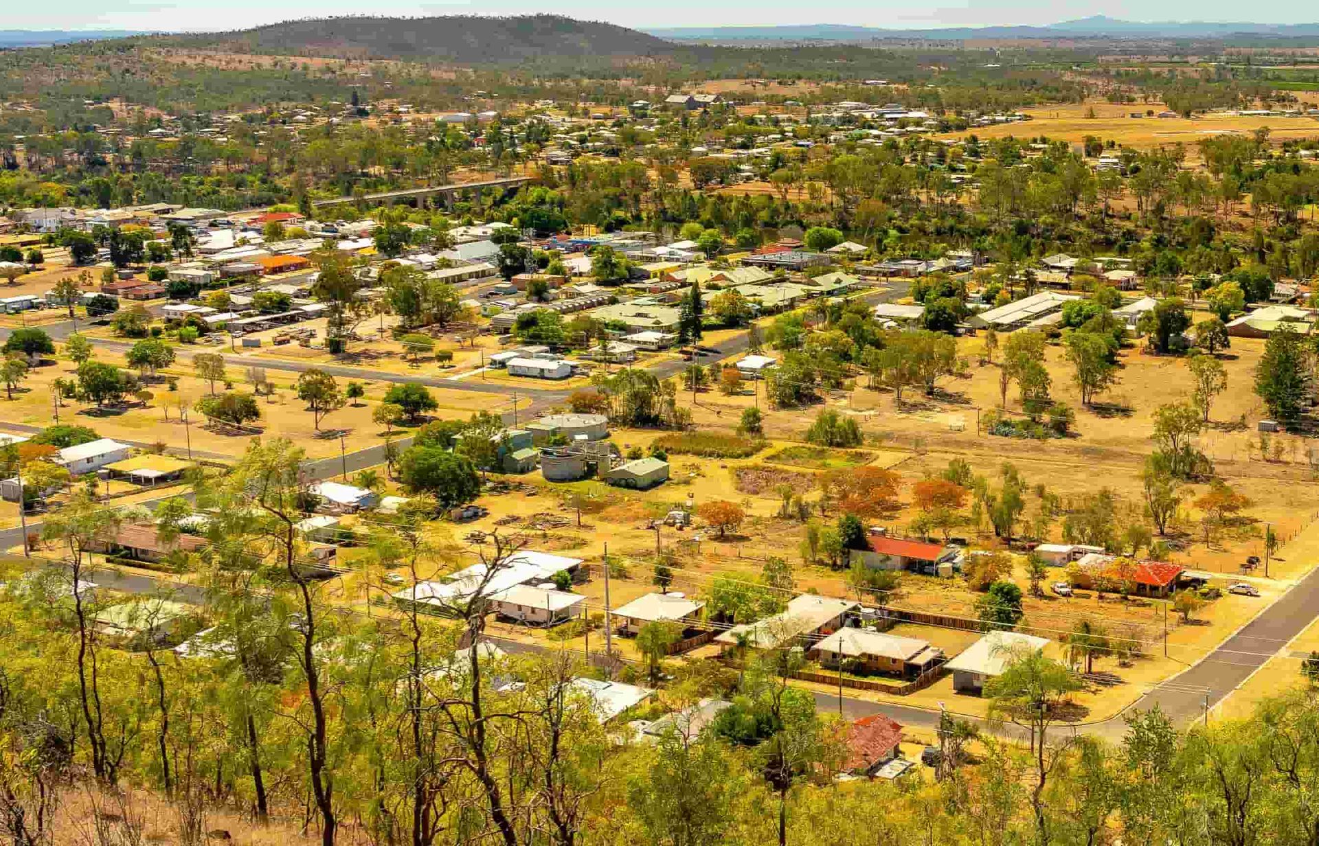 An aerial view of a small town surrounded by trees and bushes  — Active Tree Fellas in Childers, QLD