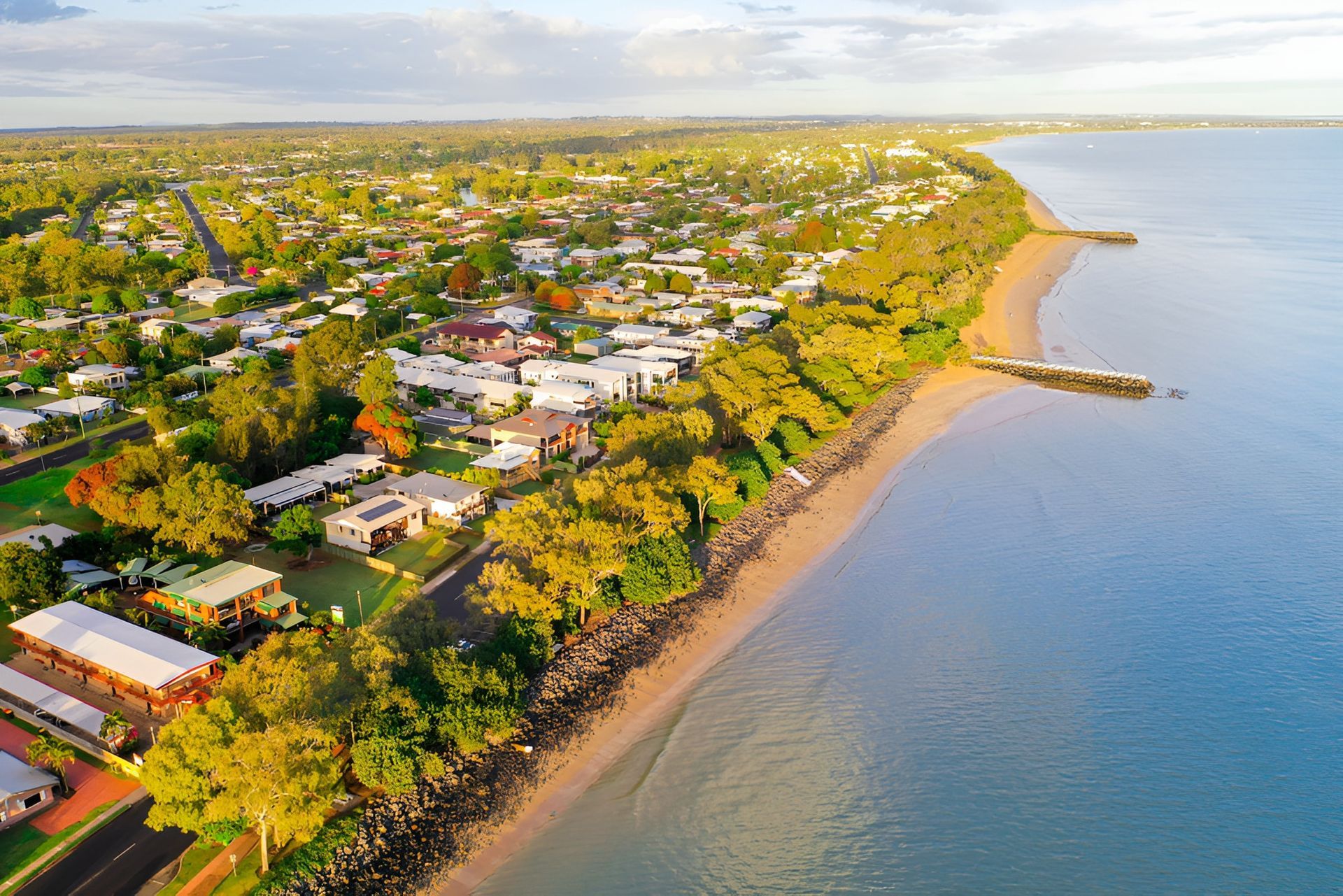 An Aerial View of a Beach With a City in the Background — Active Tree Fellas in Maryborough, QLD