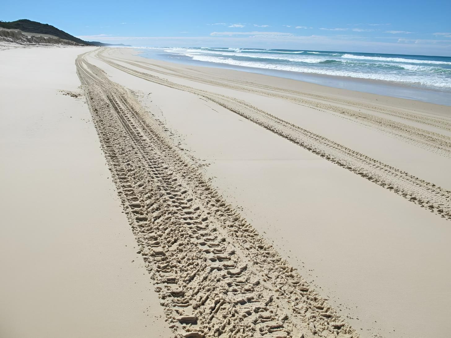 A Sandy Beach With Tire Tracks in the Sand — Active Tree Fellas in Fraser Coast, QLD