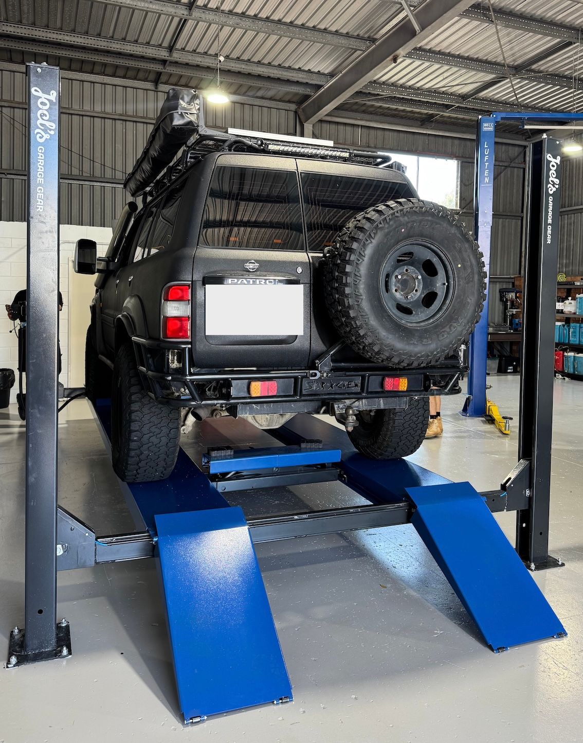 Nissan Patrol 4WD Parked On Hoist— Axton Automotive Services in Kunda Park, QLD