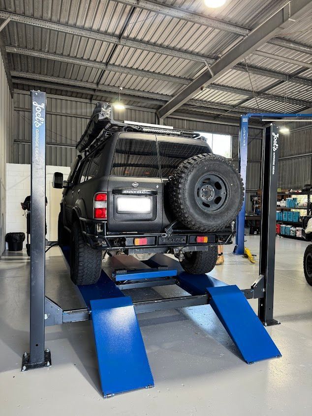 Mechanic Writing On Clipboard On Top Of Engine — Axton Automotive Services in Kunda Park, QLD