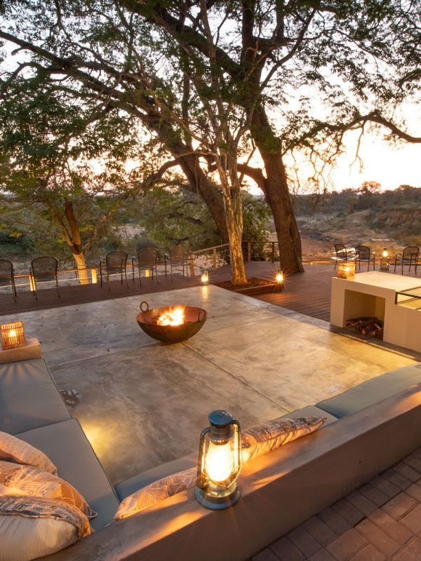 a lantern sits next to a fire pit on a patio