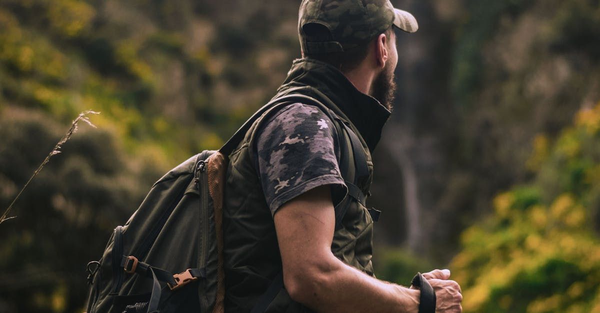 A man with a backpack is walking through a forest.