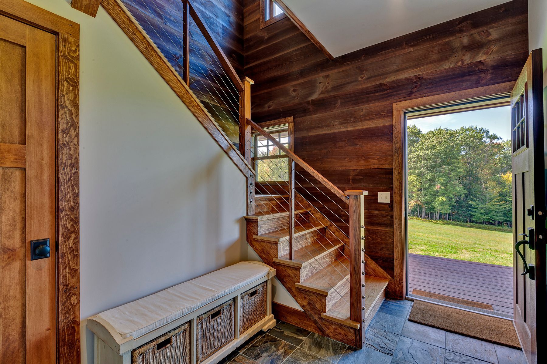 A wooden staircase is leading up to the second floor of a house.