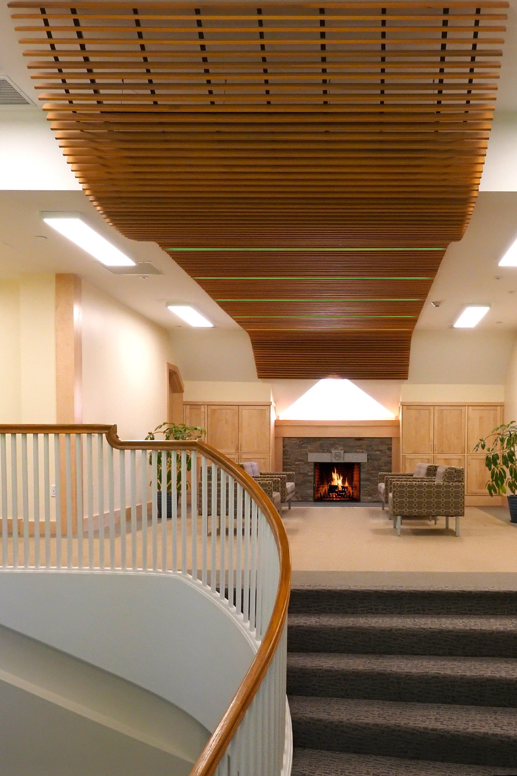 A room with a fireplace and stairs leading up to it