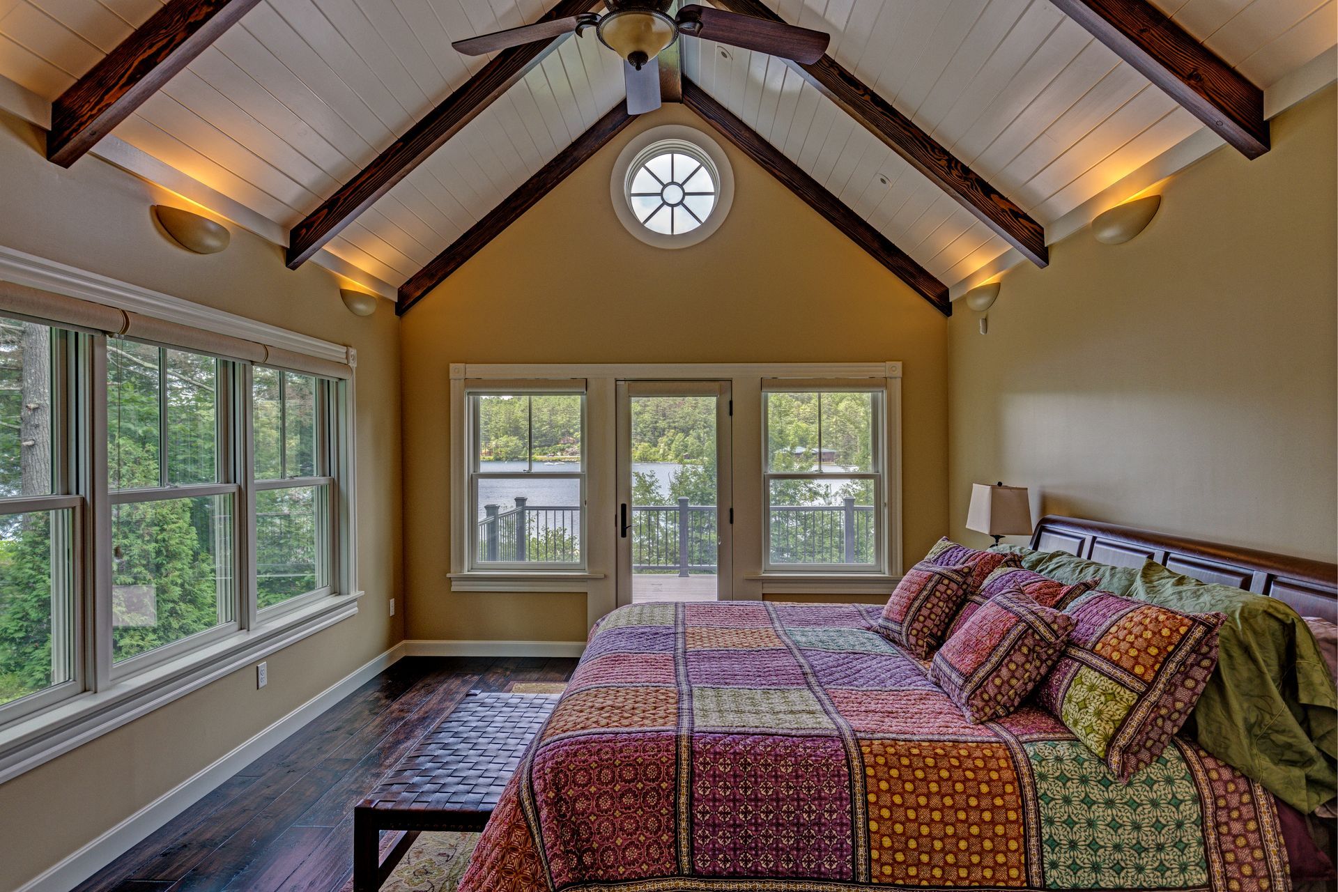 A bedroom with a vaulted ceiling and a large bed