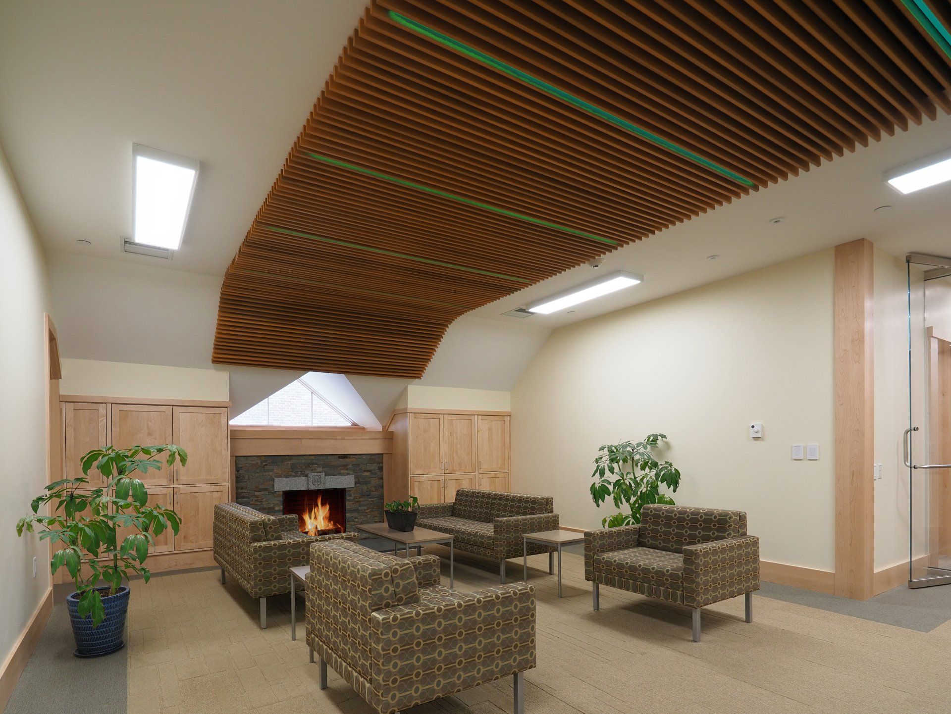 A living room with a fireplace and chairs