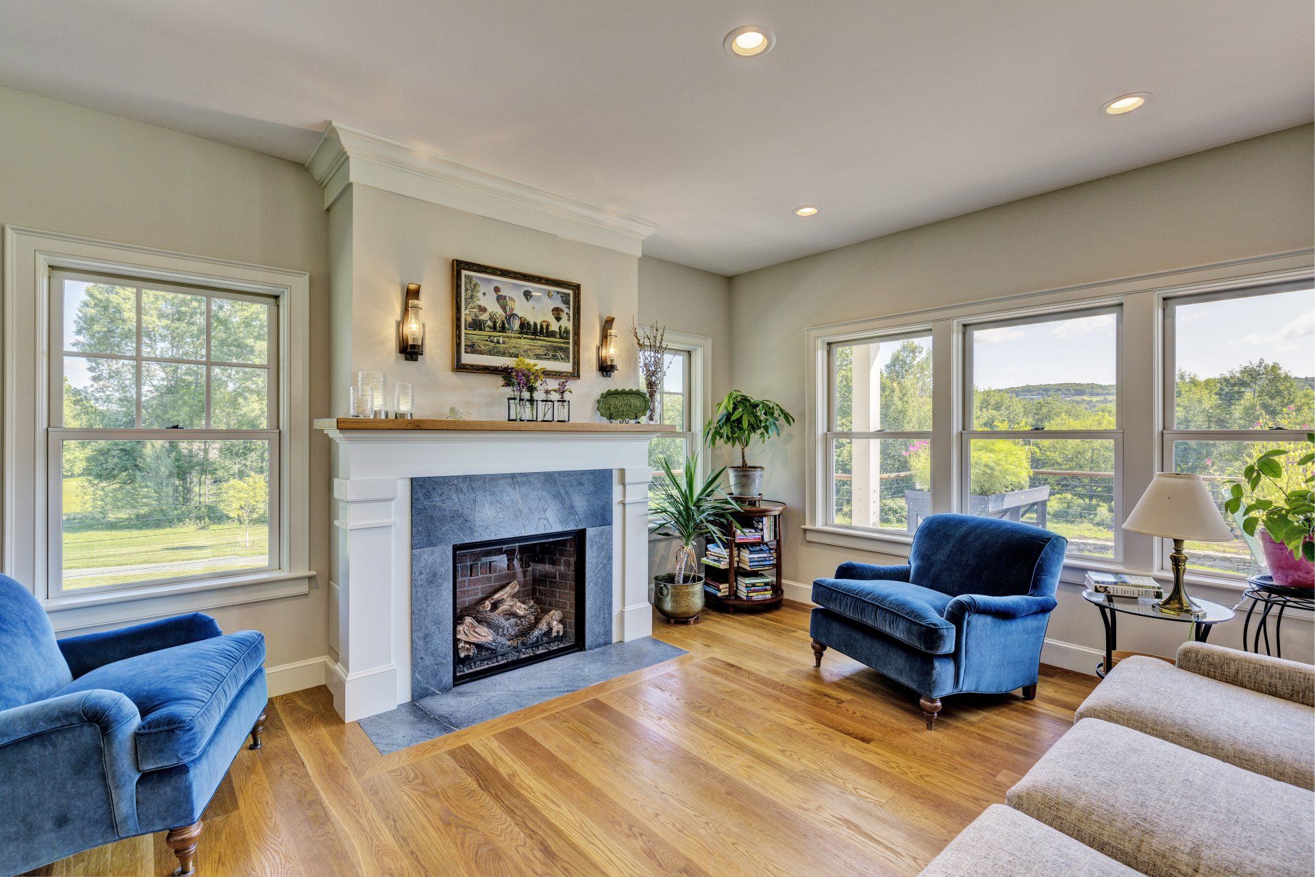 A living room with a fireplace , chairs , and a couch.