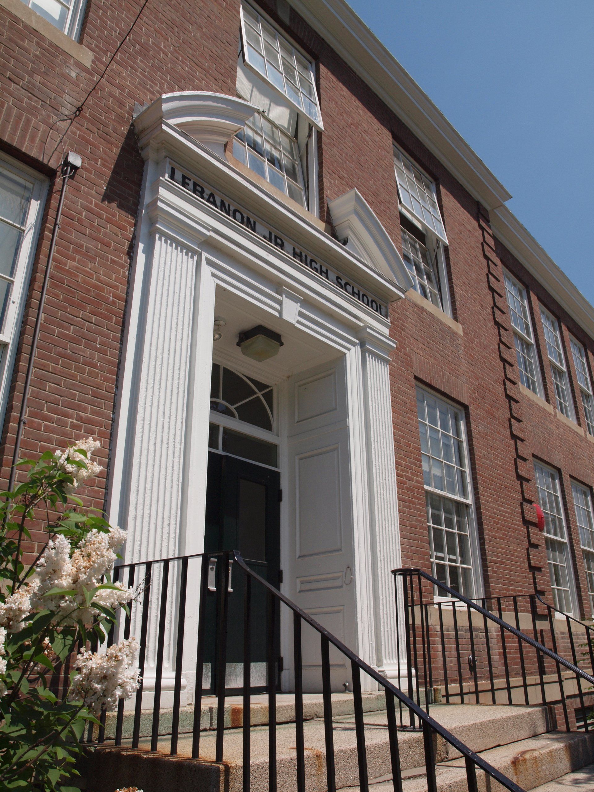 A large brick building with stairs leading up to the entrance