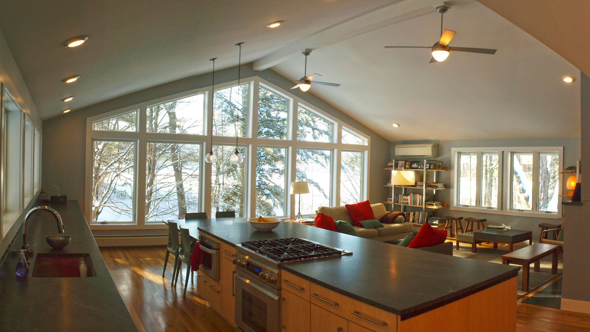 A kitchen with a large island and a stove top oven
