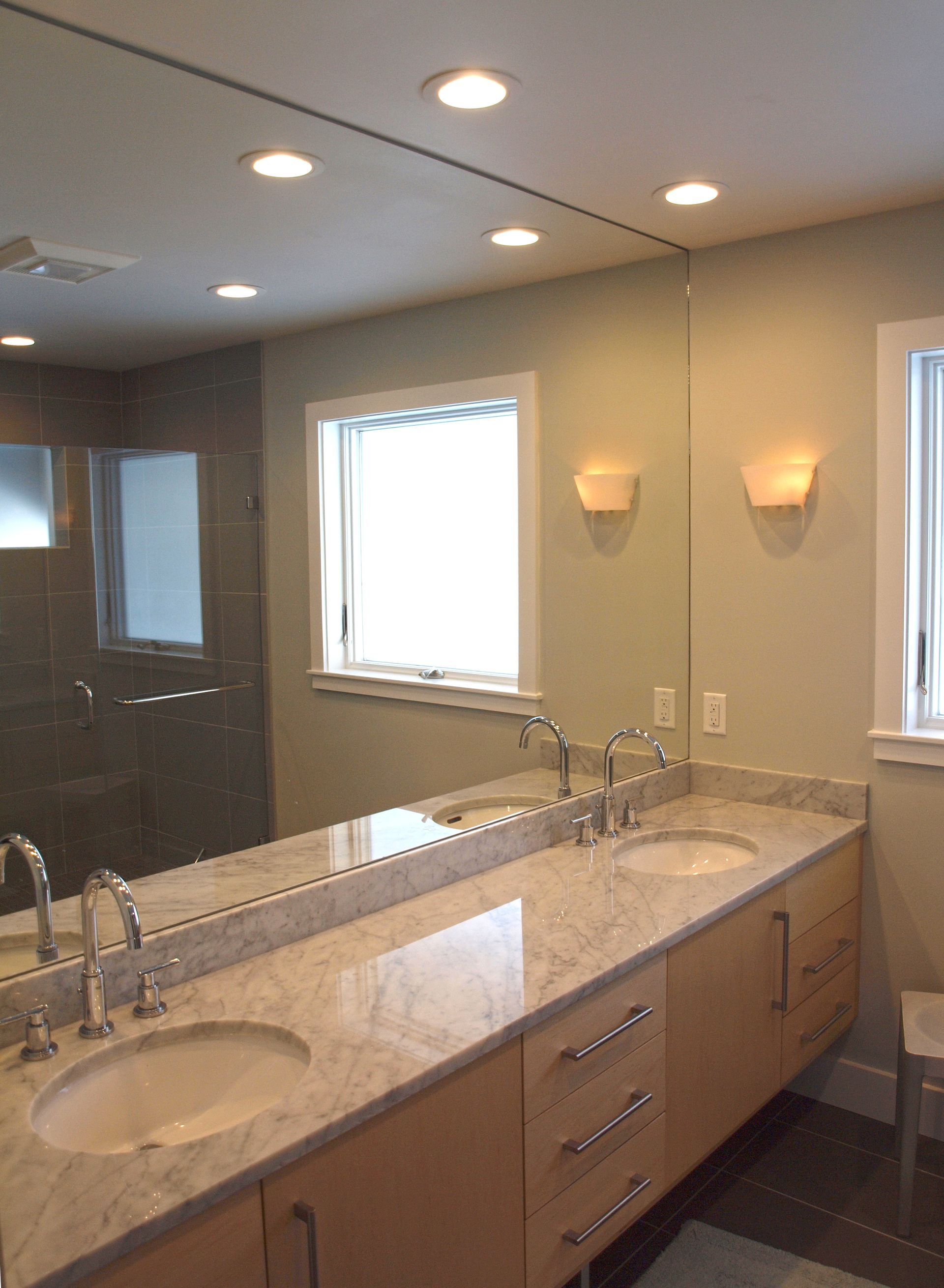 A bathroom with two sinks and a large mirror