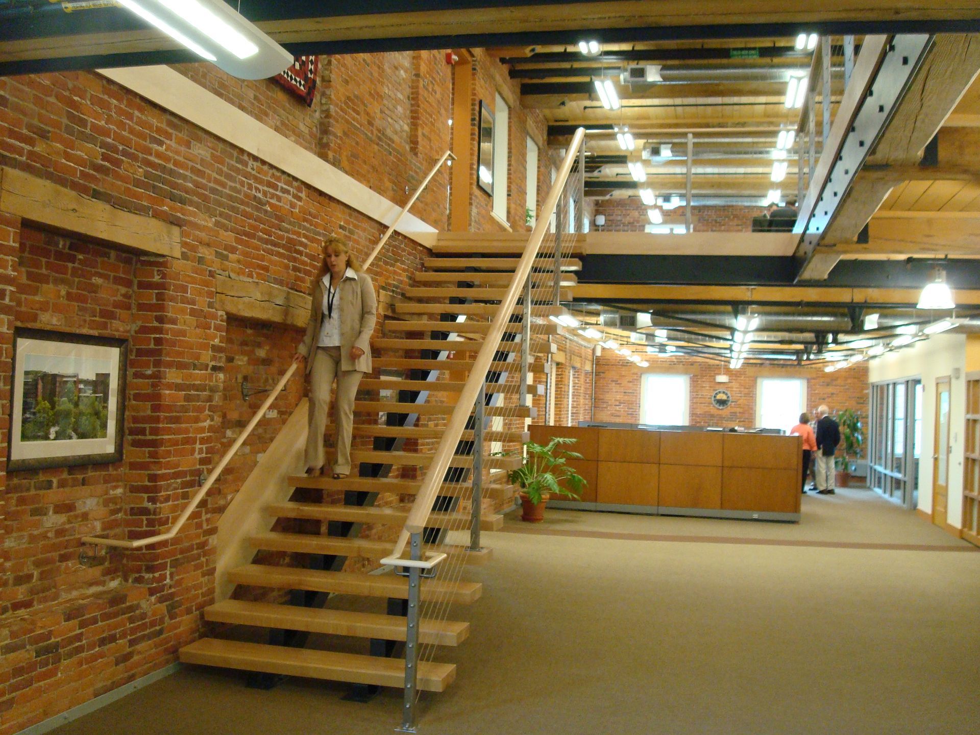 A woman is walking up a set of wooden stairs