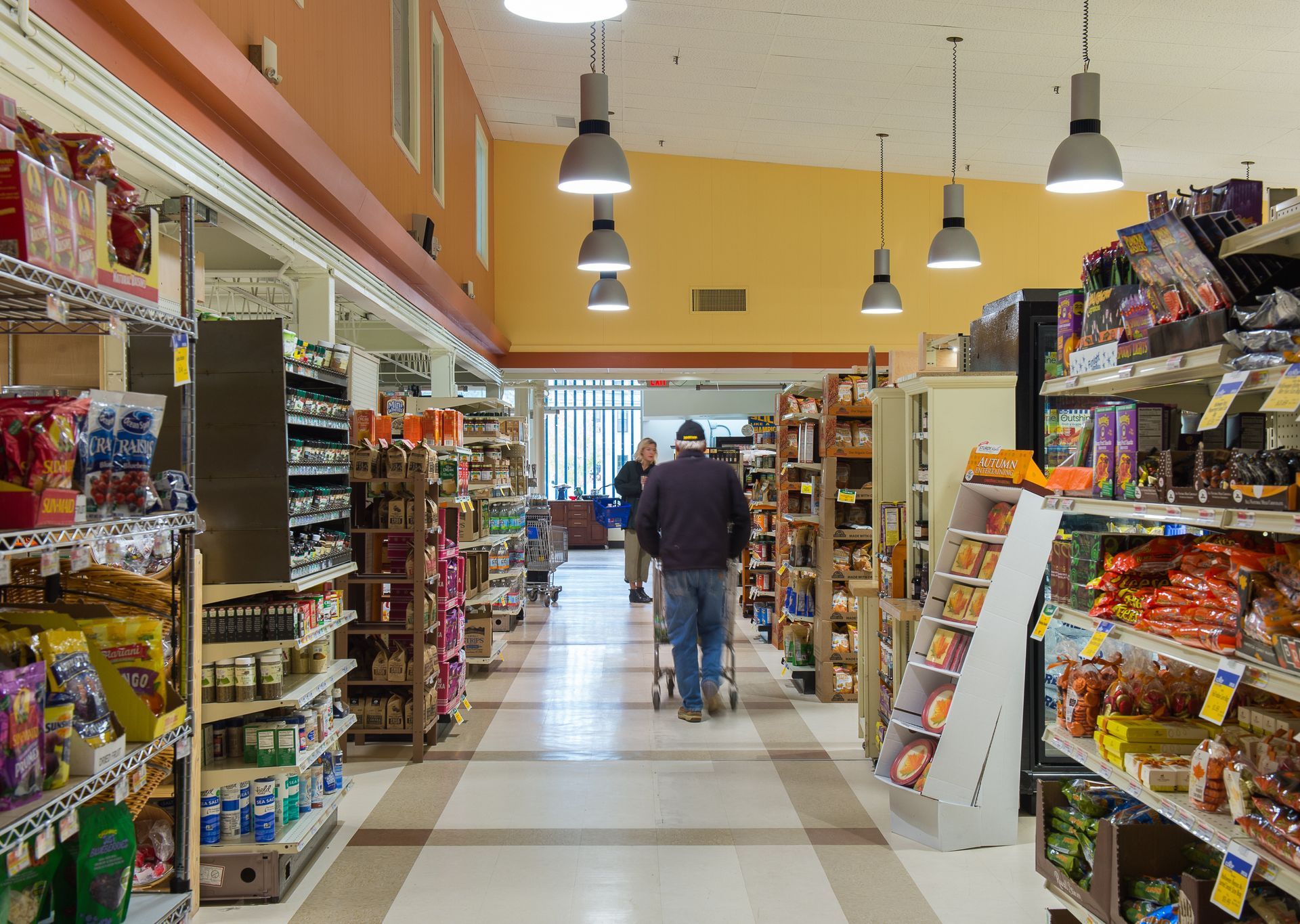 A man pushing a shopping cart in a grocery store