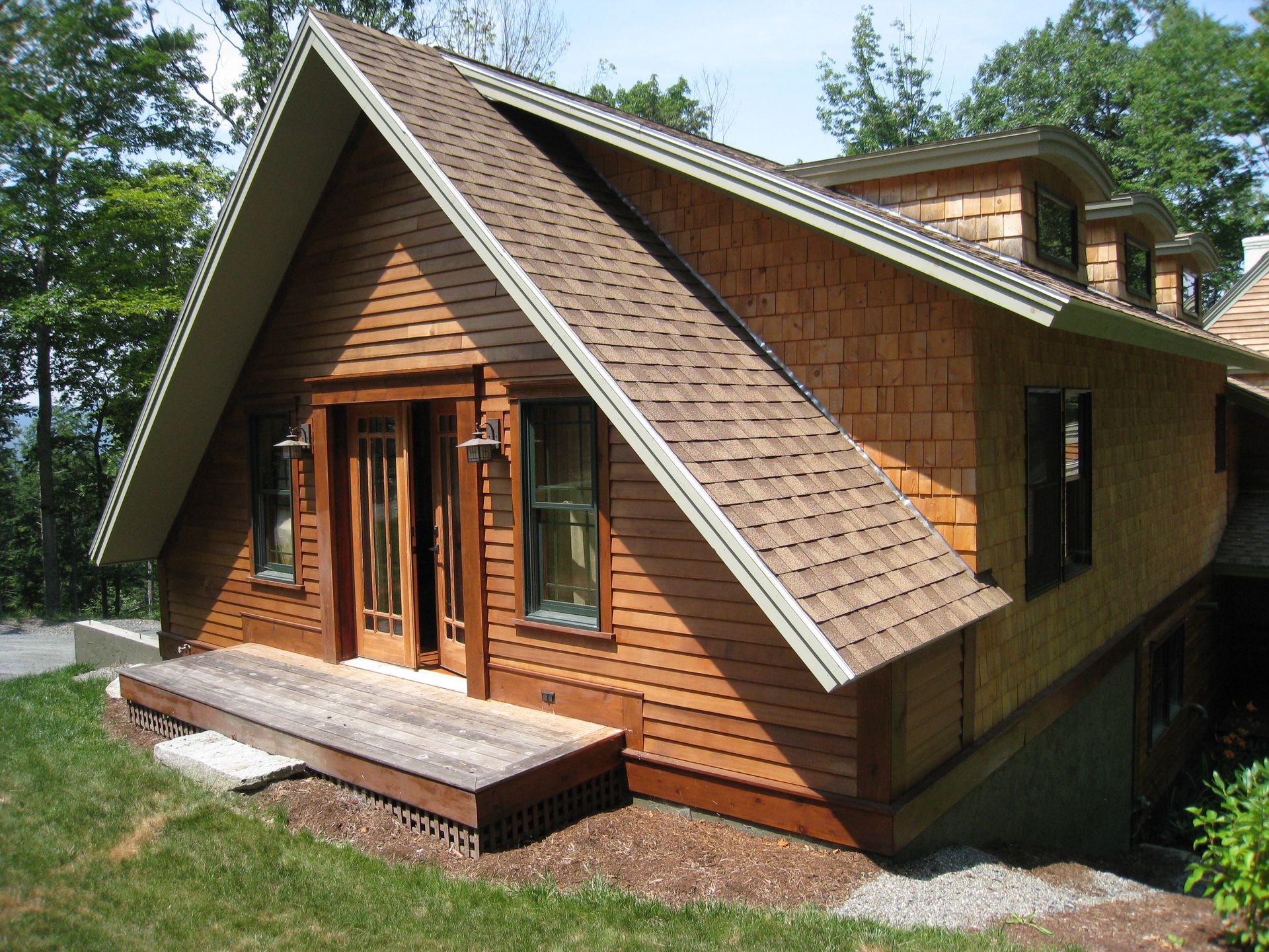 A small wooden house with a brown roof
