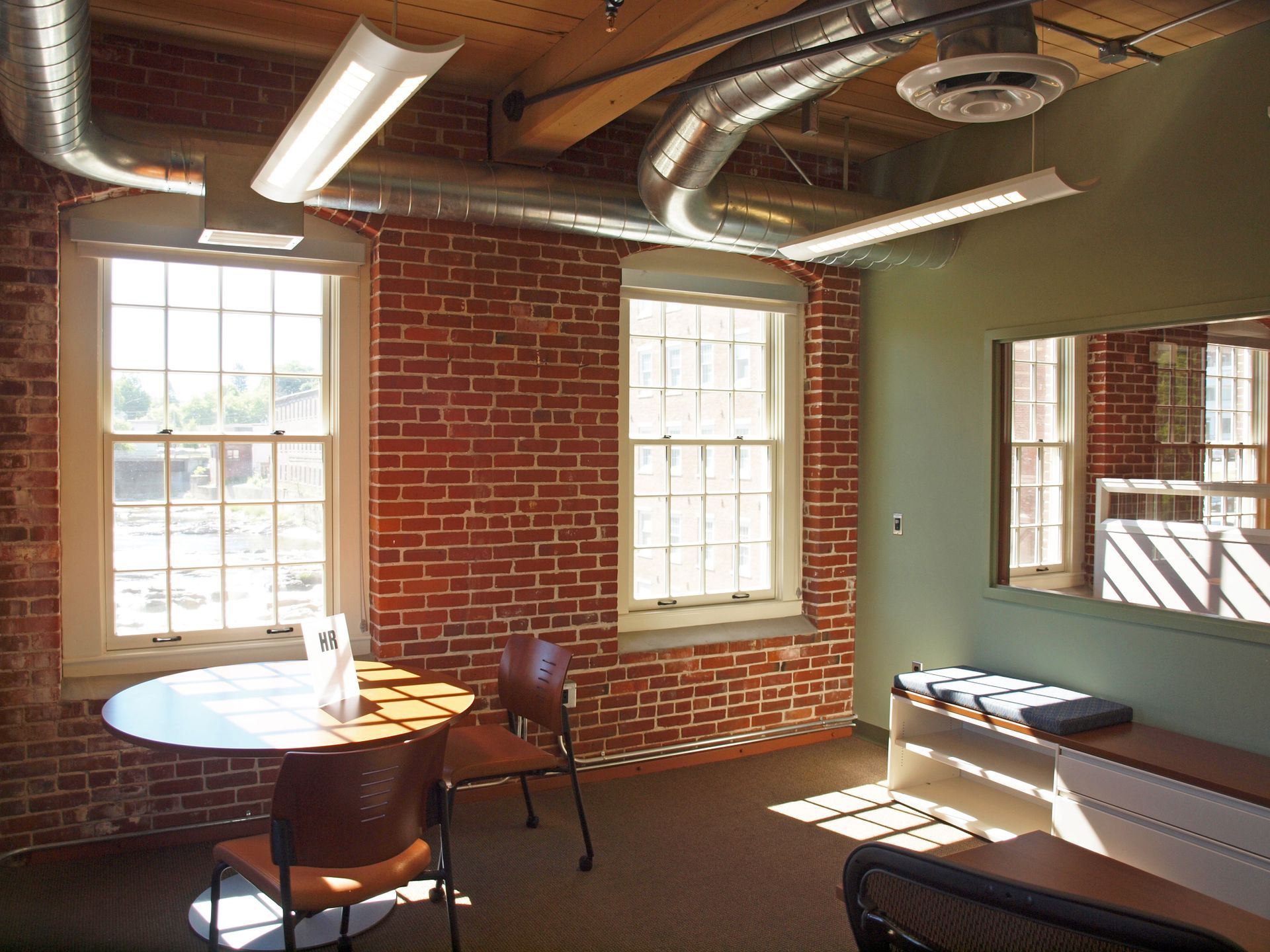 A room with a brick wall and a table and chairs
