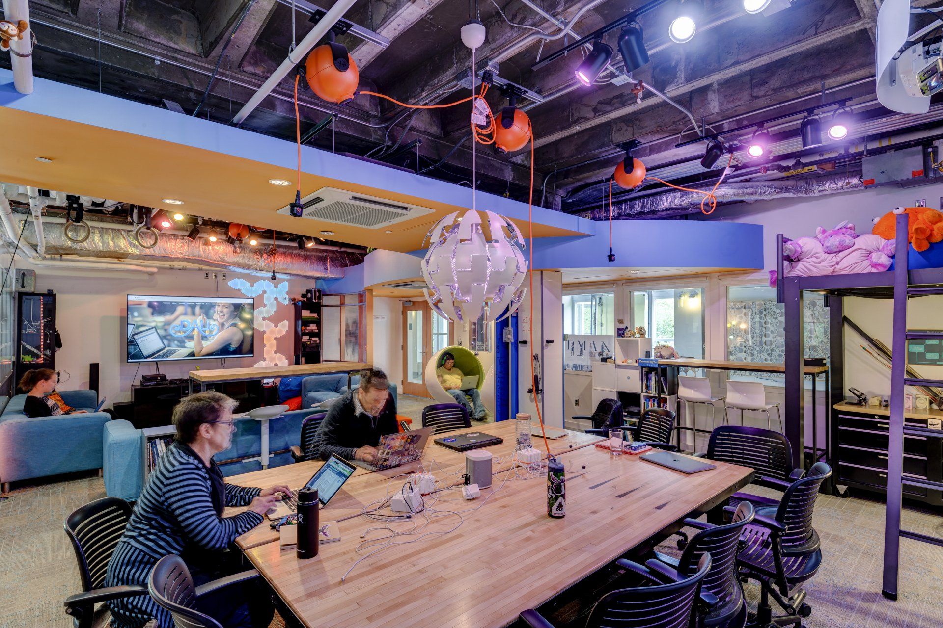 A group of people are sitting at a table in a room.