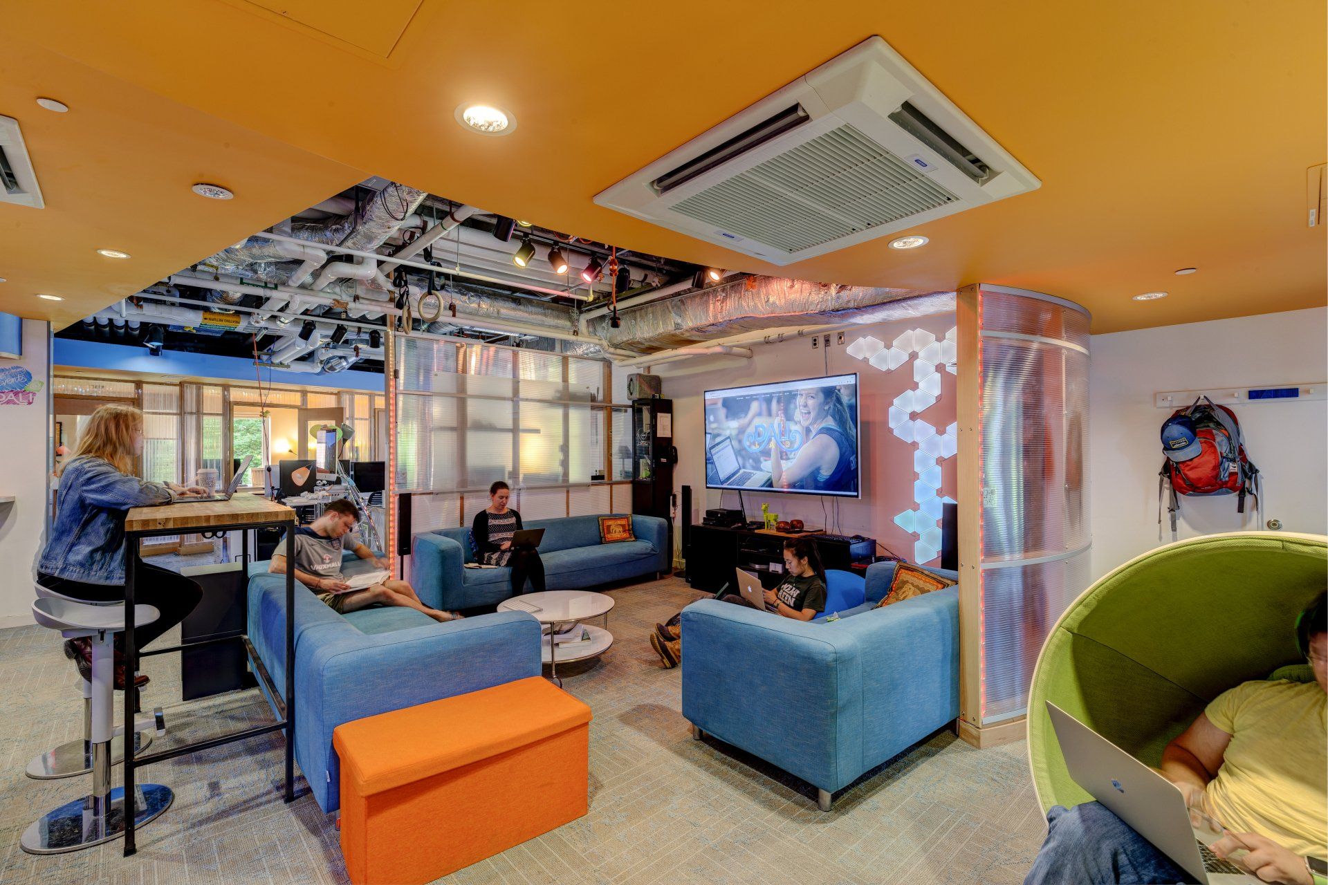 A group of people are sitting on couches in a living room.