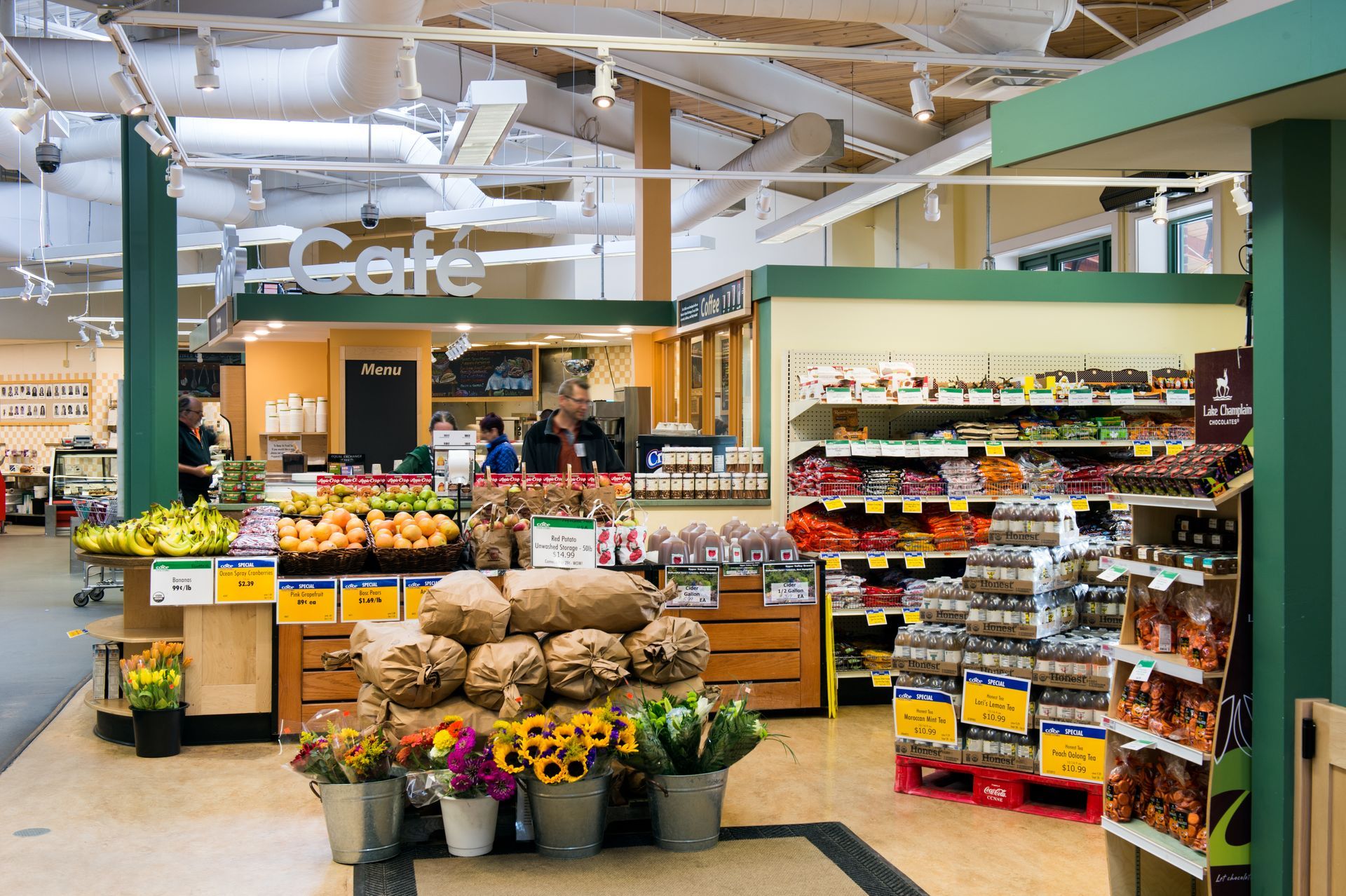 The inside of a grocery store with a sign that says cafe
