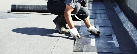 man installing commercial roof