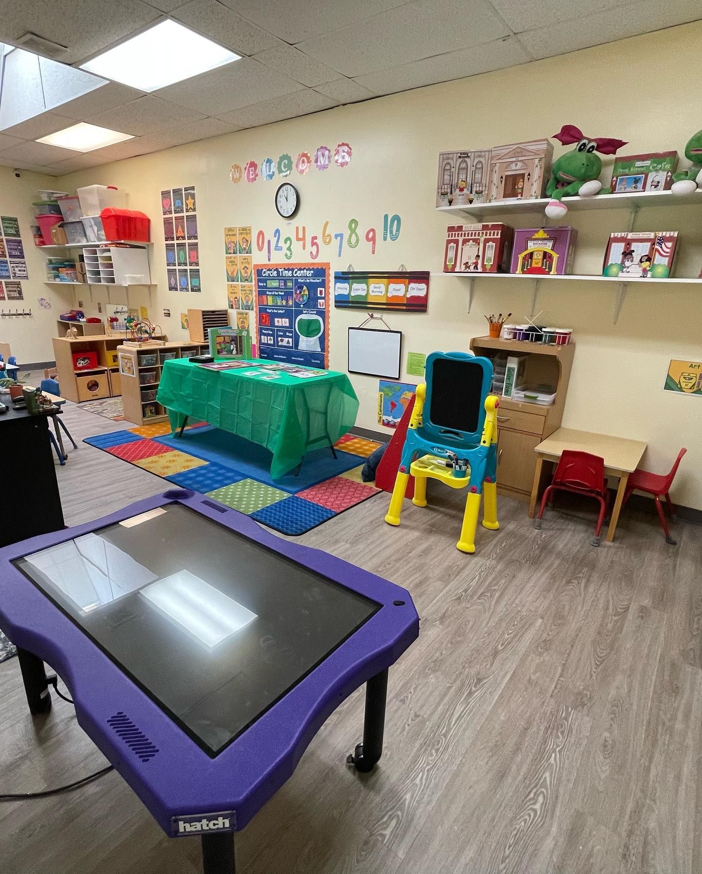 a purple table in a classroom with a touchscreen