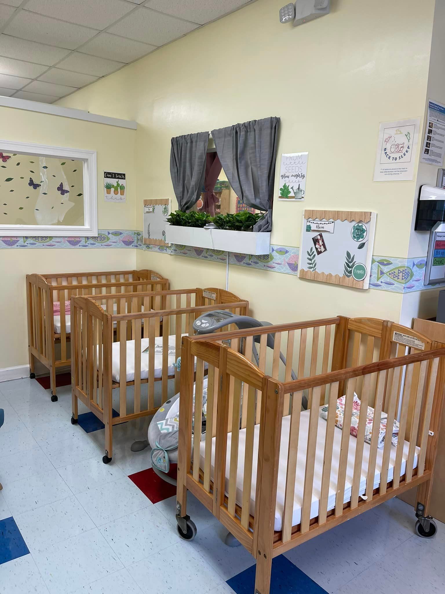 a row of wooden cribs are lined up in a room .