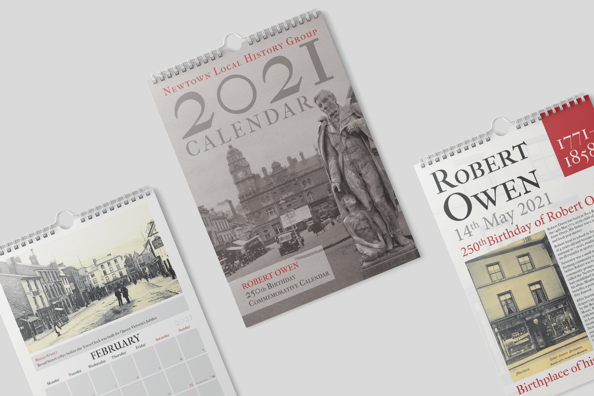 Newtown History Group - Brand & Flair Graphic Design - Three calendars are sitting on top of each other on a table.