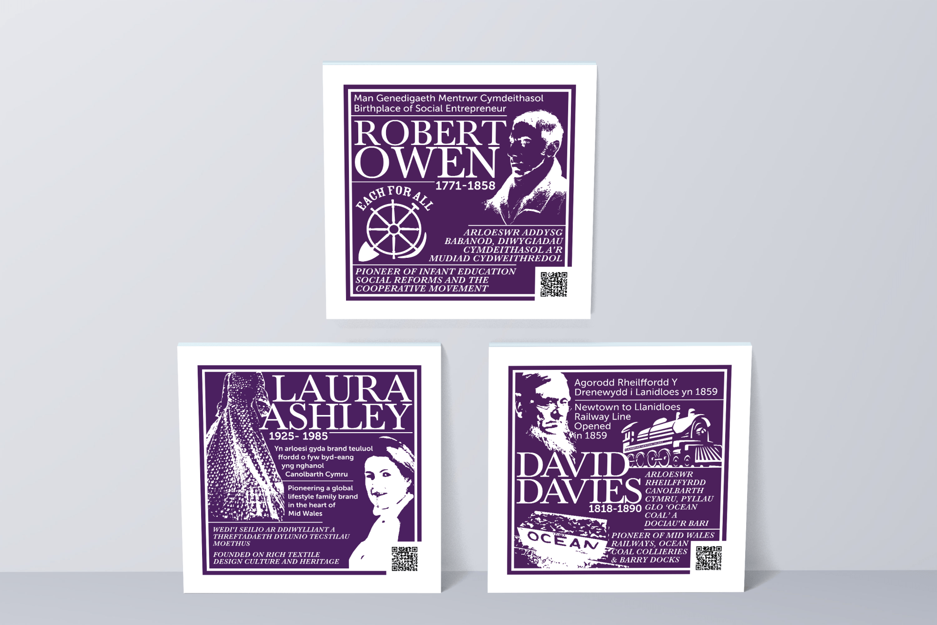 Three posters of robert owen , laura ashley and david davies are sitting on a table.