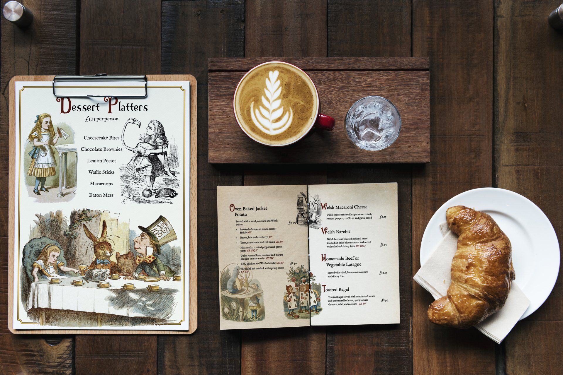 A wooden table with a clipboard , a cup of coffee , a croissant and a menu.
