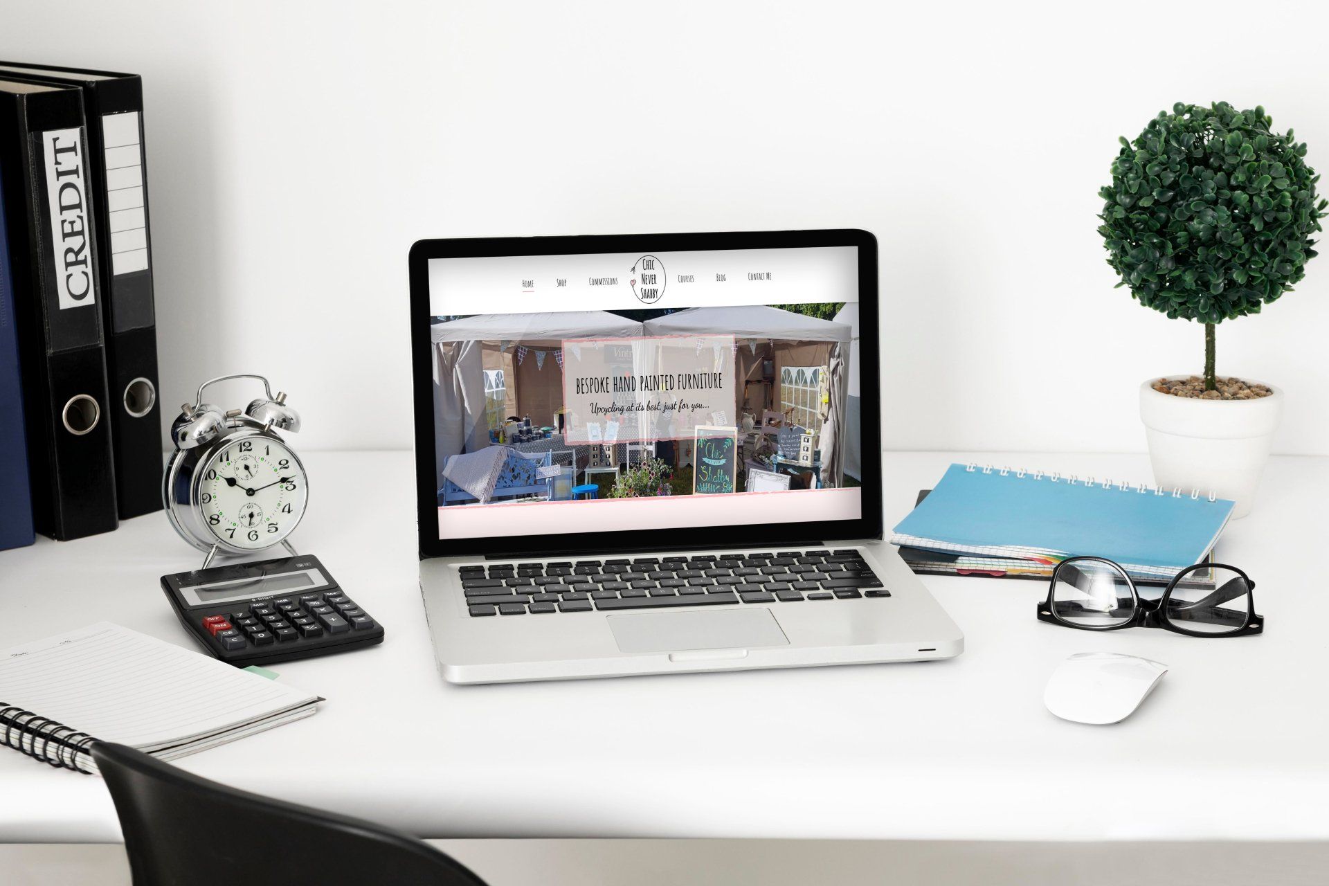 A laptop computer is open to a website on a desk.
