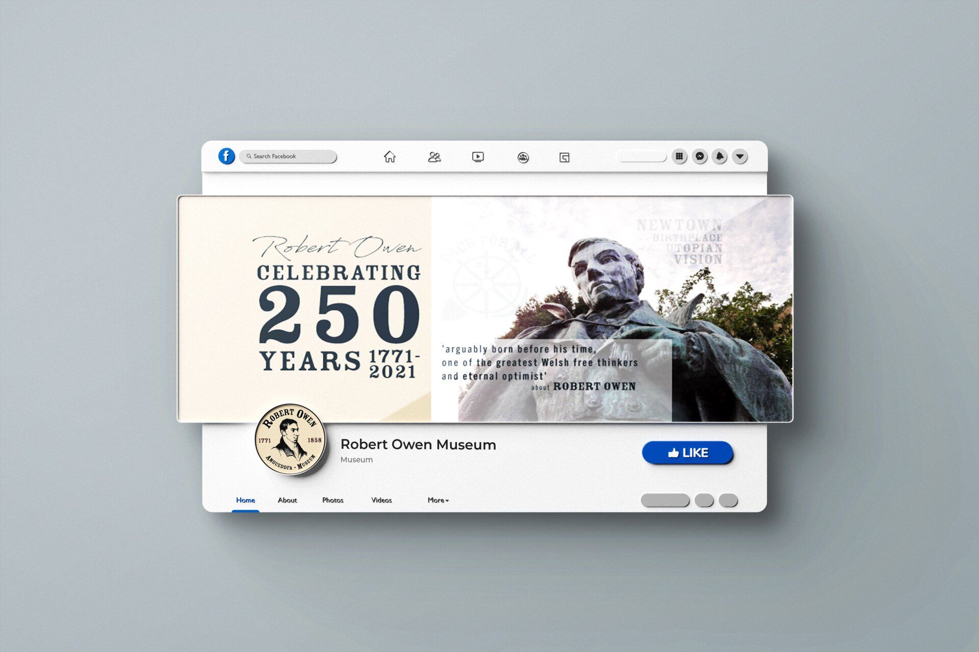 A statue of a man is sitting on top of a computer screen.