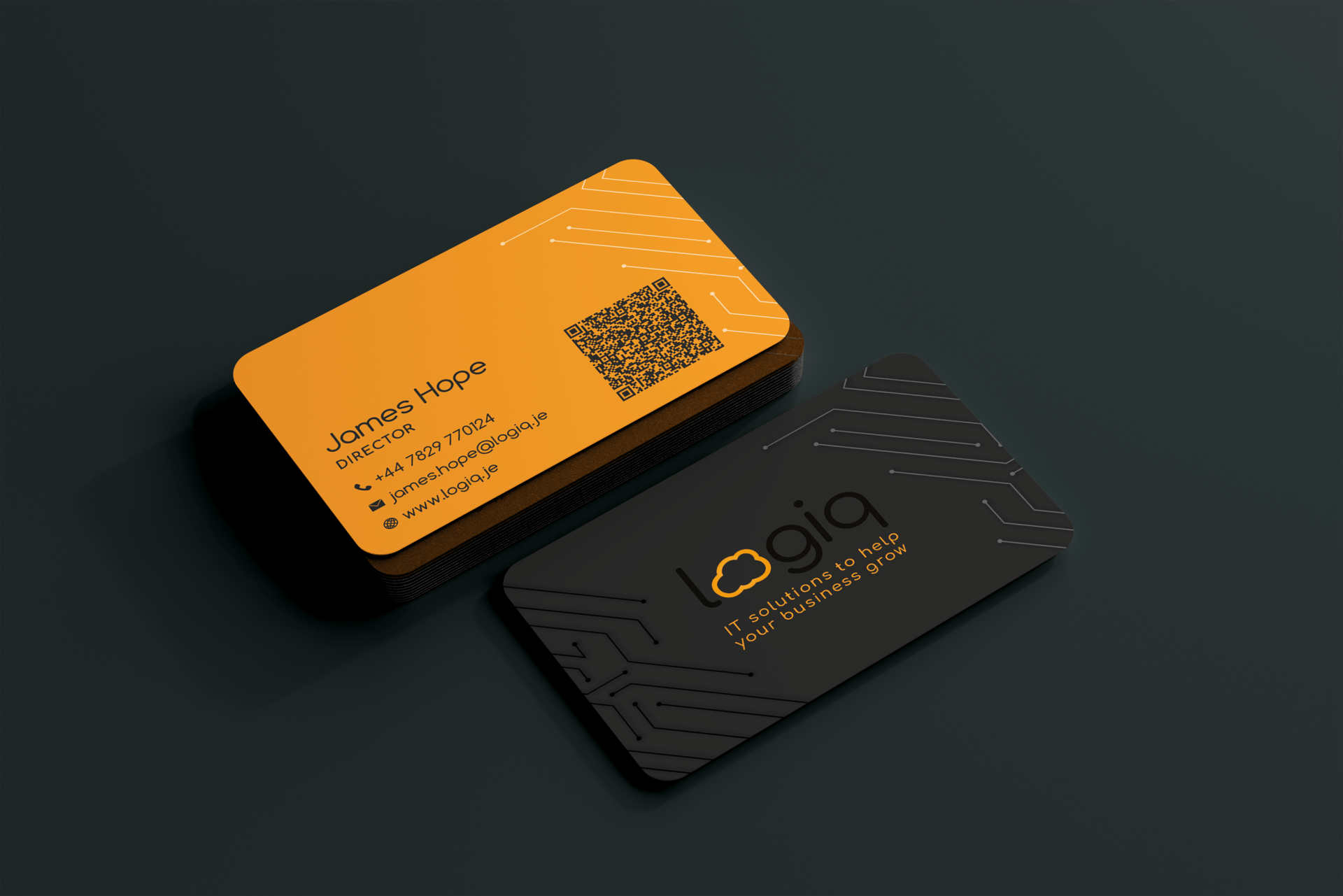 Two business cards are sitting on top of each other on a black surface.