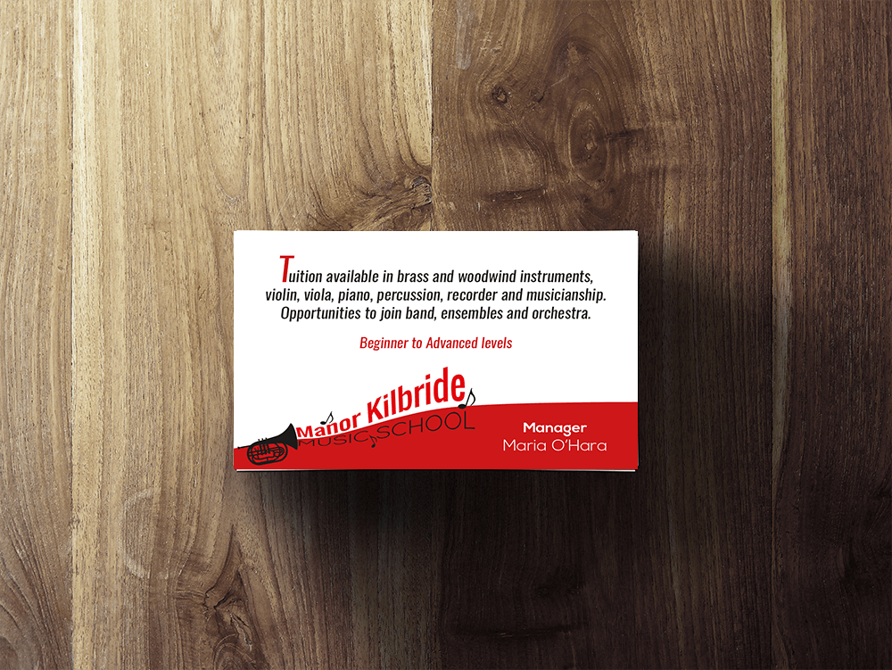 A business card on a wooden surface that says tailor kitbride
