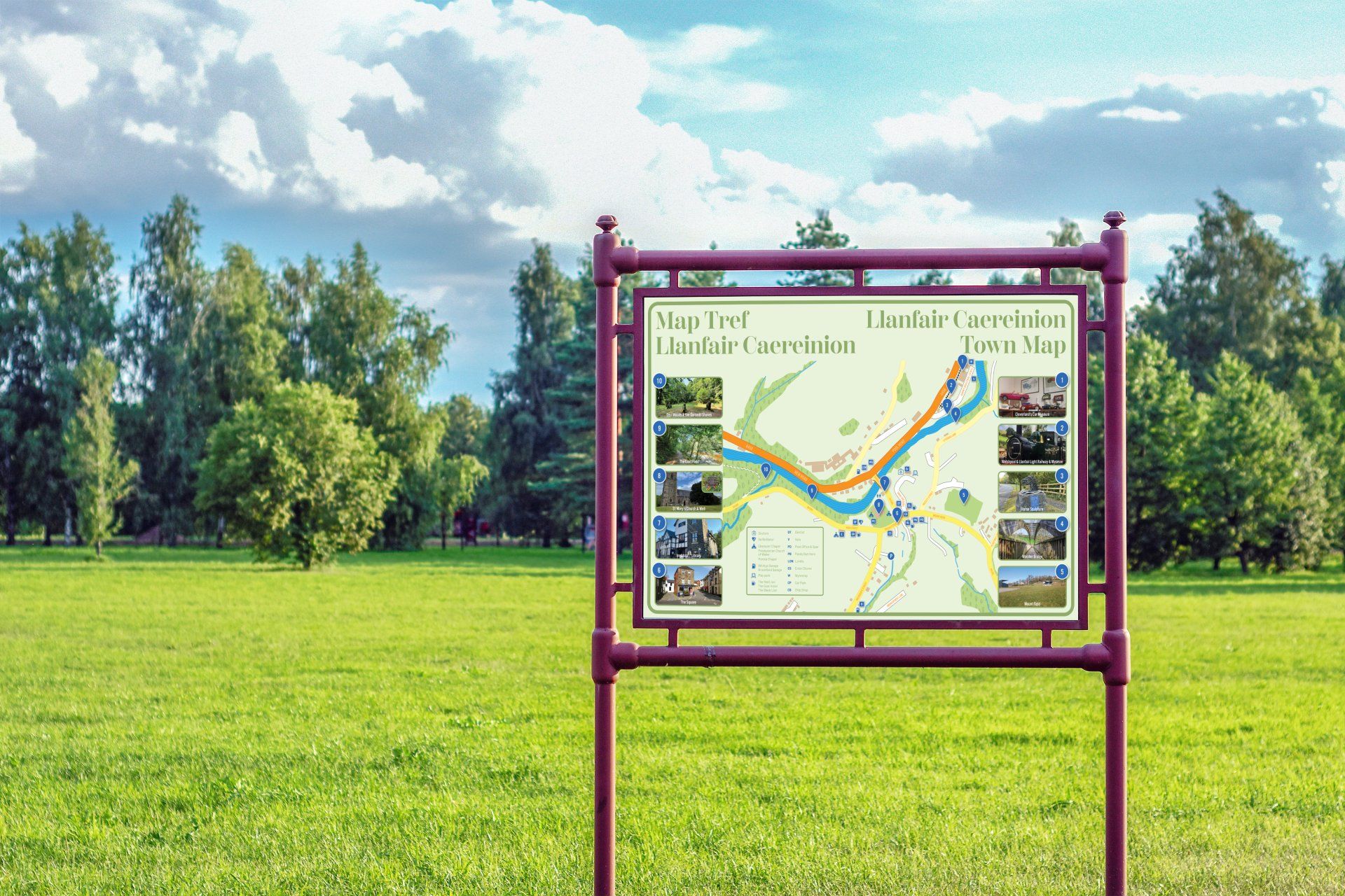 A map on a pole in a park with trees in the background.