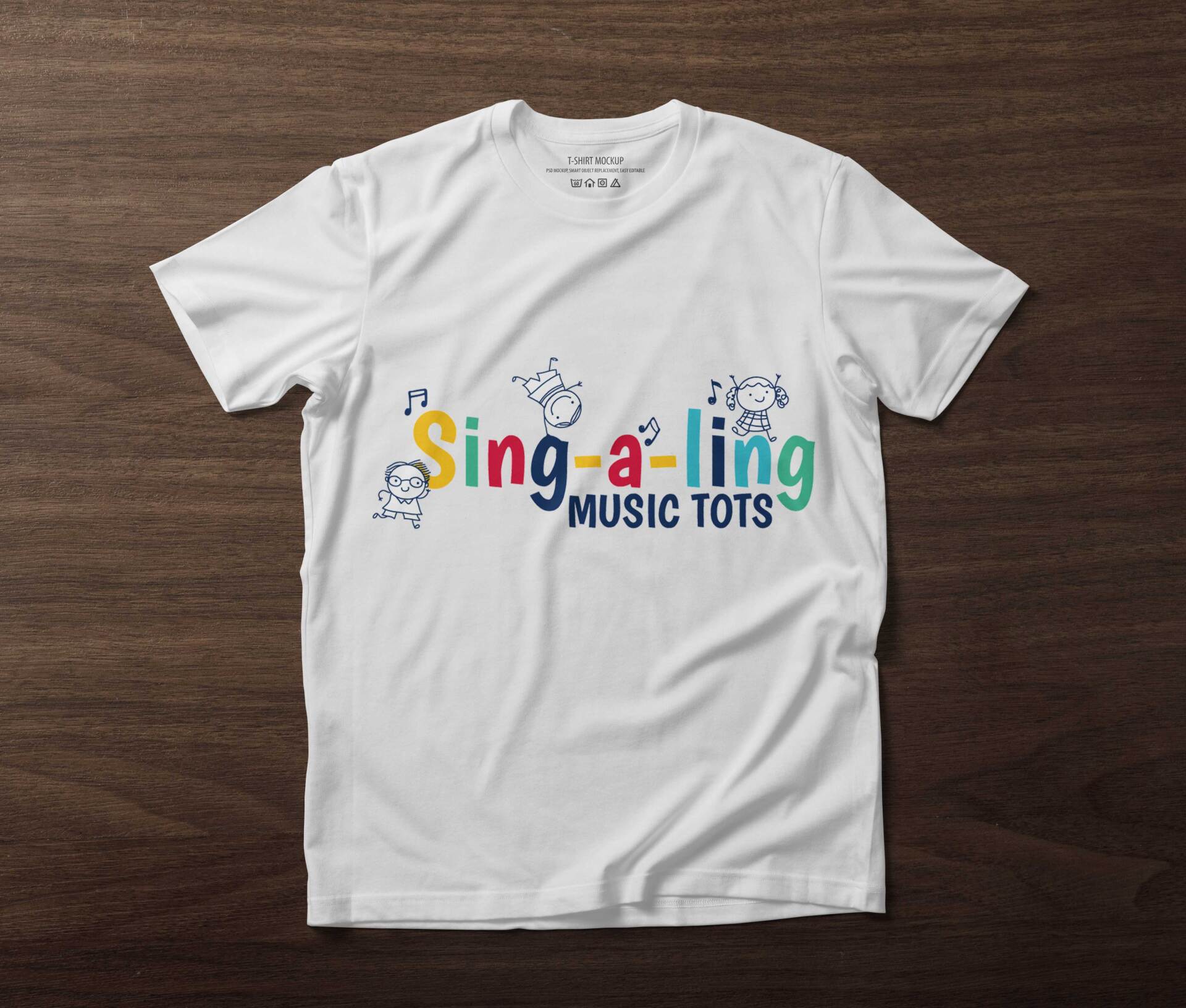 A white t-shirt that says sing-a-ling music tots