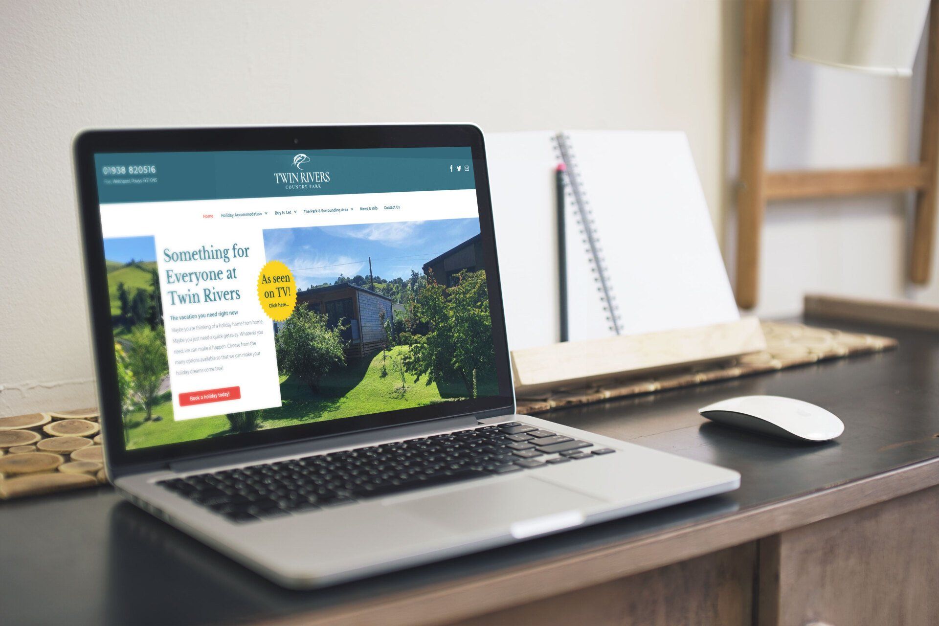 A laptop computer is open to a website on a desk.