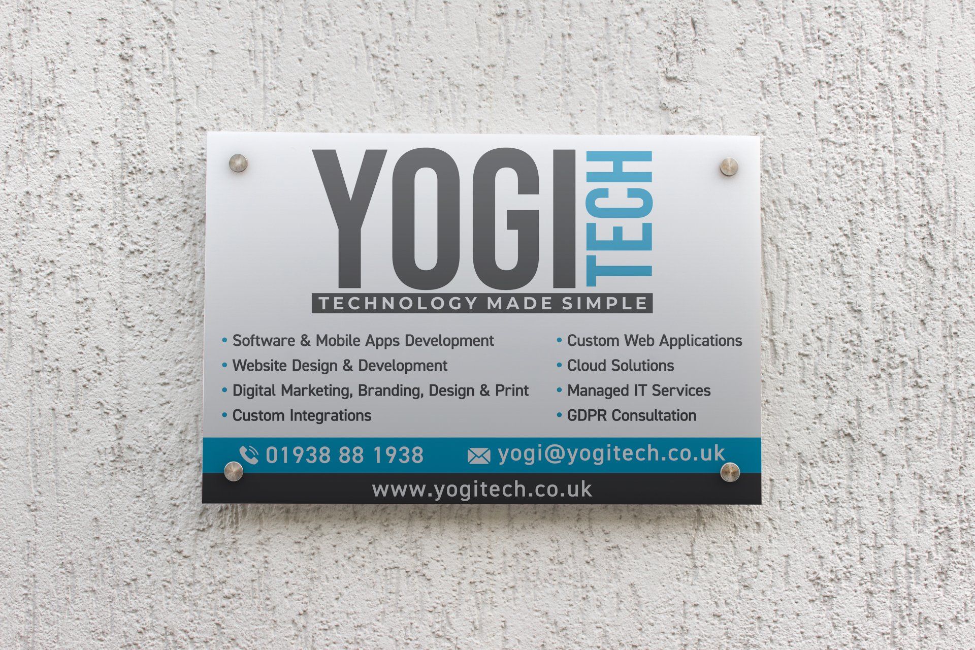A sign on a wall that says yogi tech technology made simple