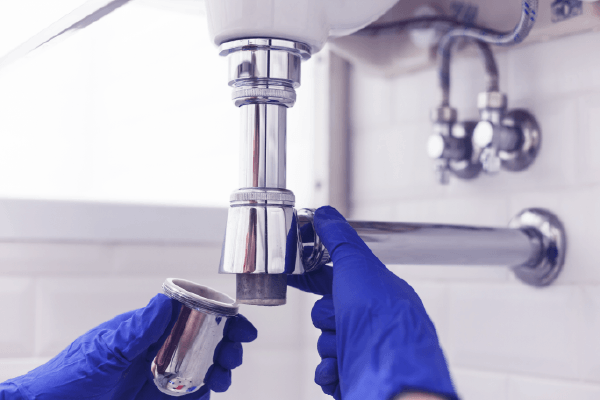 plumbing work being down under a sink