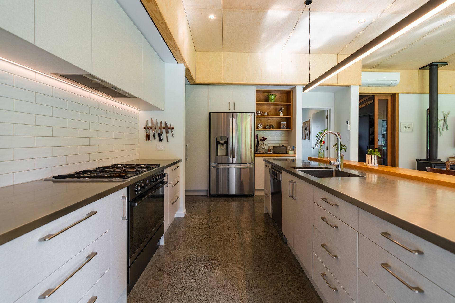 A kitchen with stainless steel appliances and white cabinets.