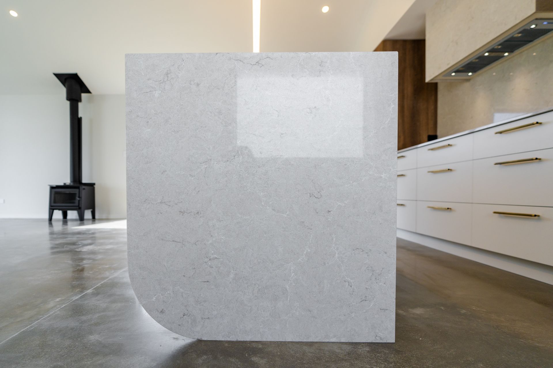 A kitchen with a white counter top and white cabinets