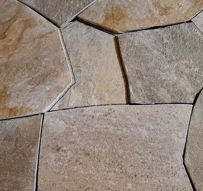 A close up of a tile floor with a geometric pattern