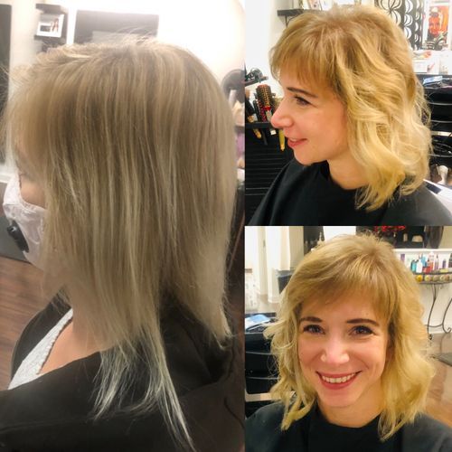 Older couple embracing on beach, woman with arms around man, both smiling.