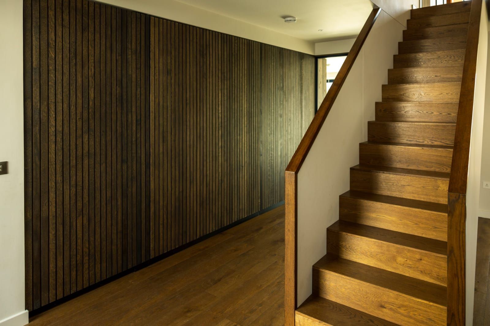 A wooden staircase leading up to the second floor of a house