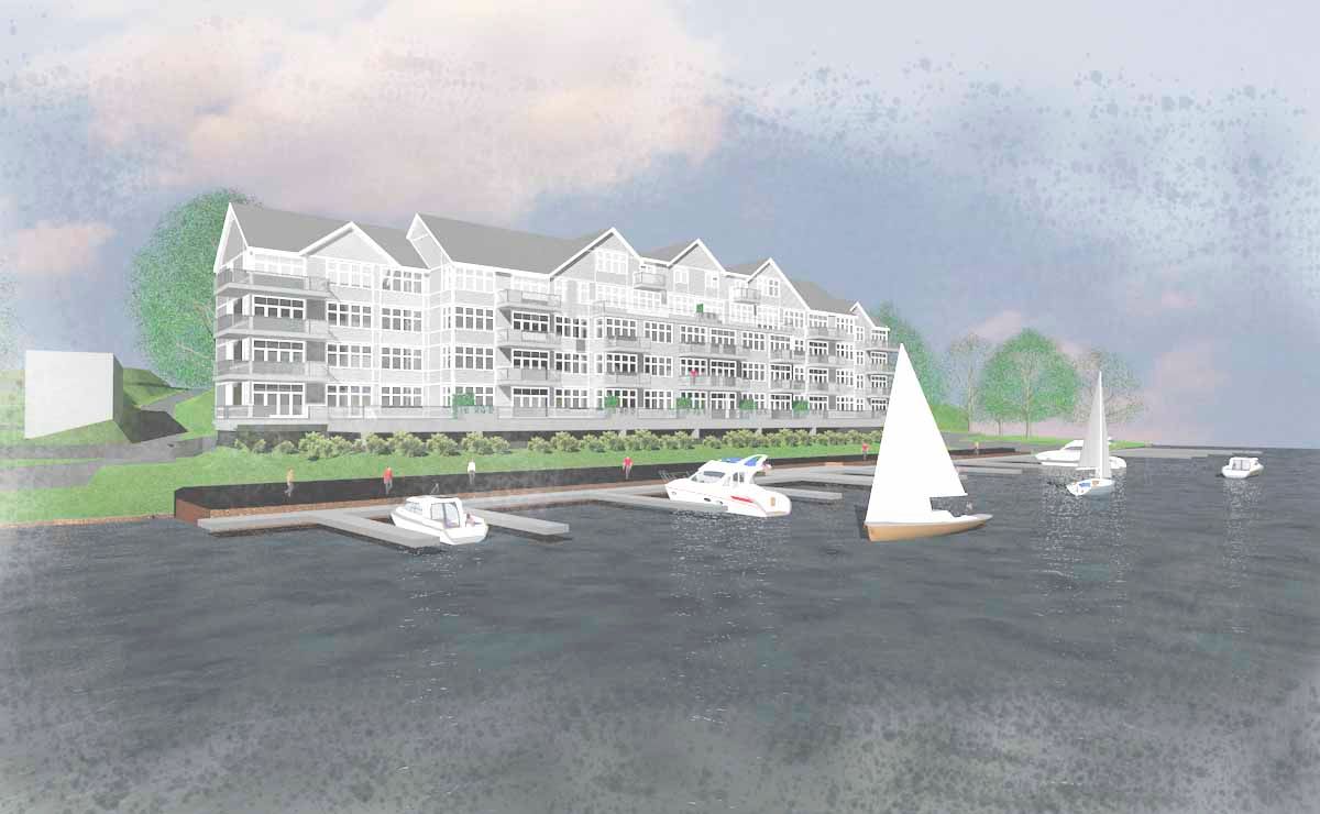 A waterfront building with boats docked in front. Gray building with multiple balconies on a body of water.