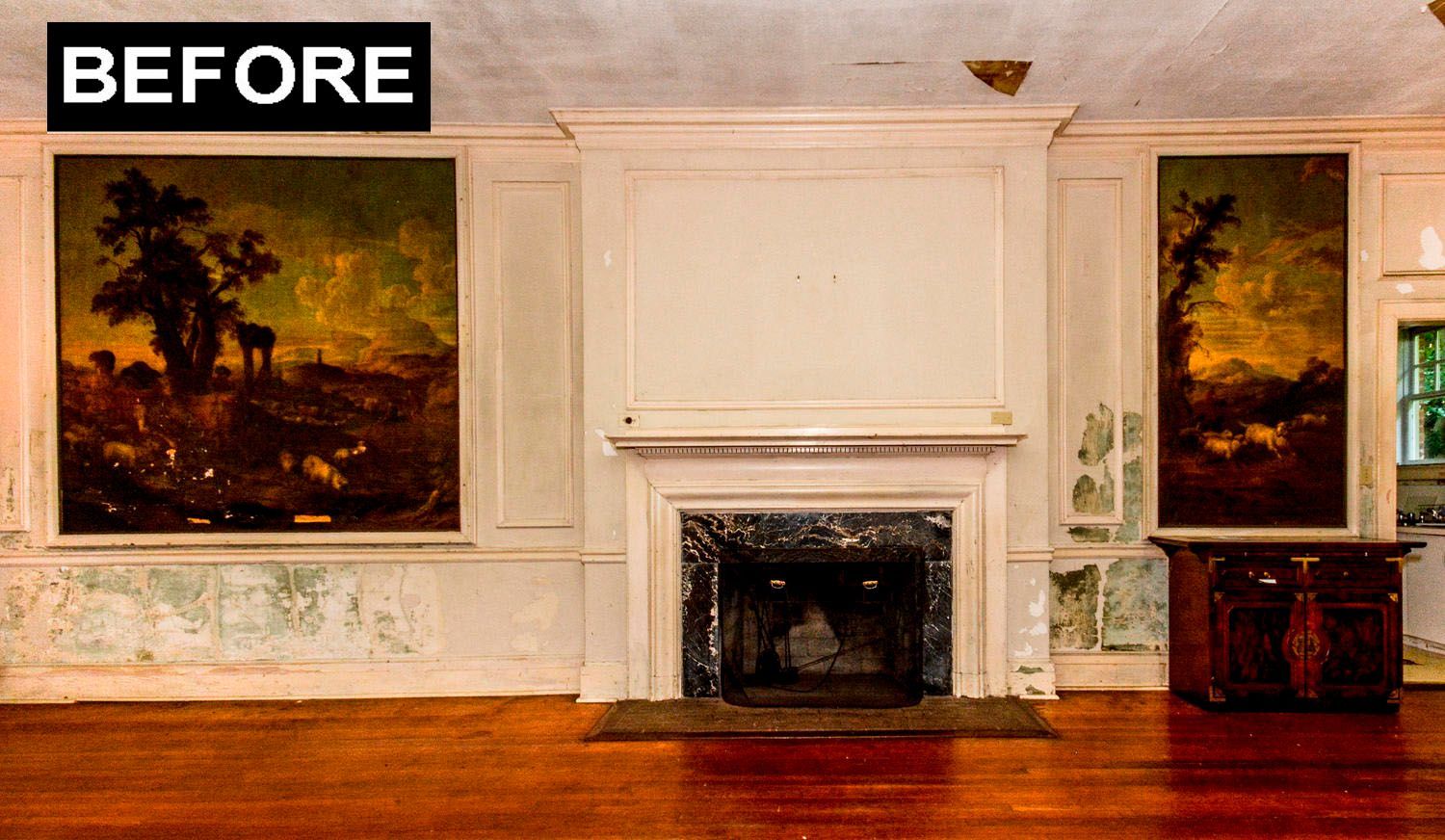 A room with a fireplace and two paintings, before renovation.  Wall and floor appear aged.