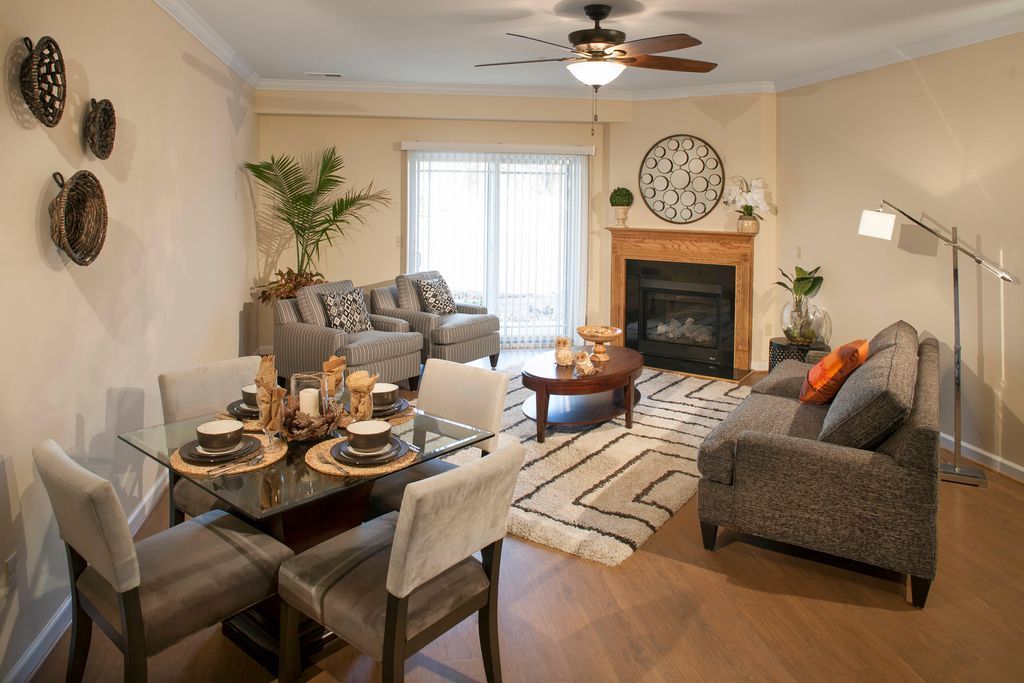 Living room with dining table, sofa, fireplace, and sliding glass doors.
