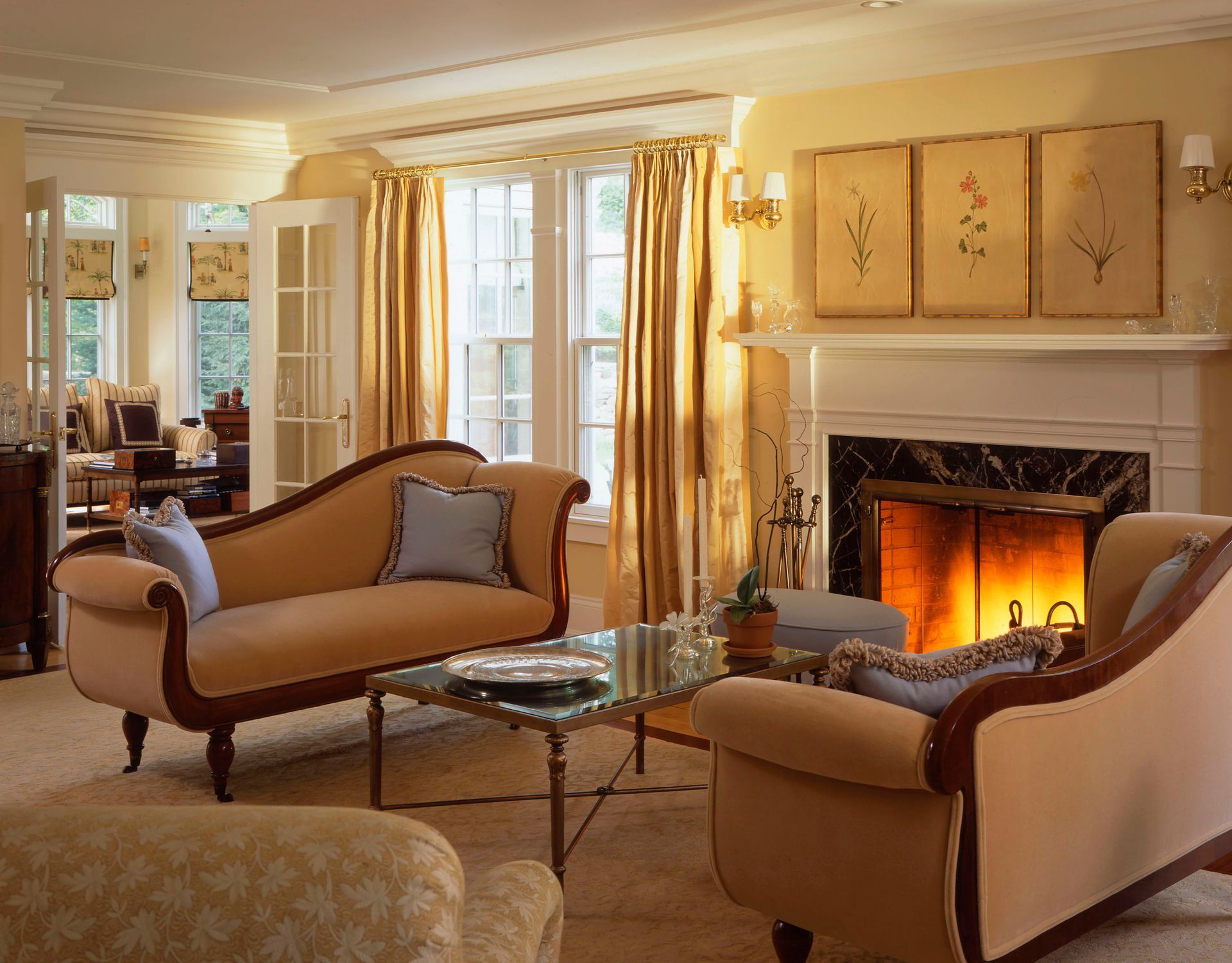 Cozy living room with beige furniture, fireplace, and glass coffee table.